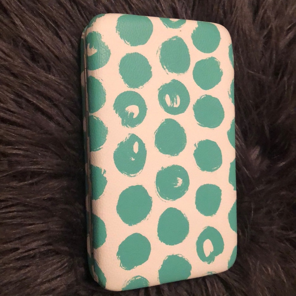 A teal and white polkadot pocketbook 😘